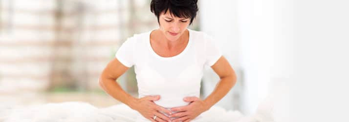 Chiropractic Lafayette LA Woman Holding Stomach